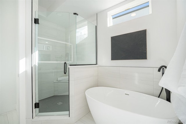 bathroom with independent shower and bath and tile walls