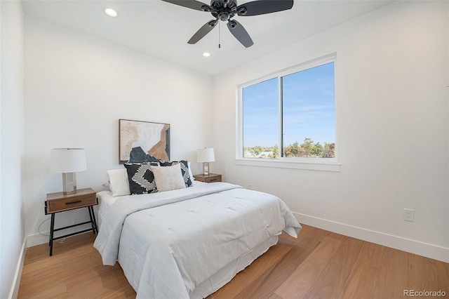 bedroom with light hardwood / wood-style floors and ceiling fan