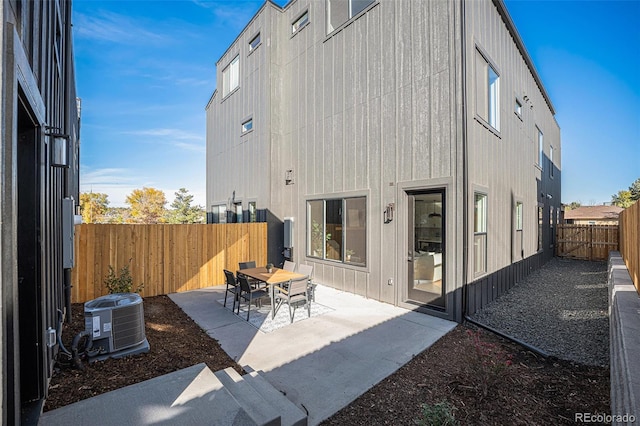 rear view of house with a patio and central AC unit