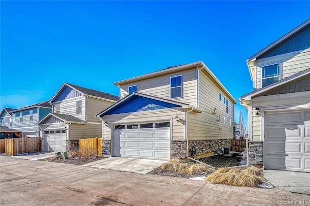 view of property with a garage and central air condition unit