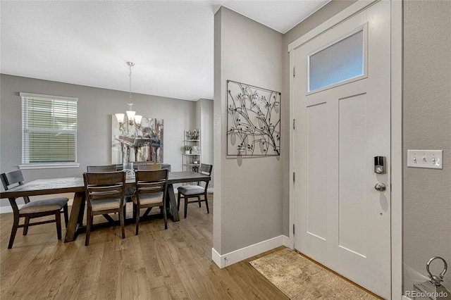 entrance foyer featuring light hardwood / wood-style floors and a chandelier