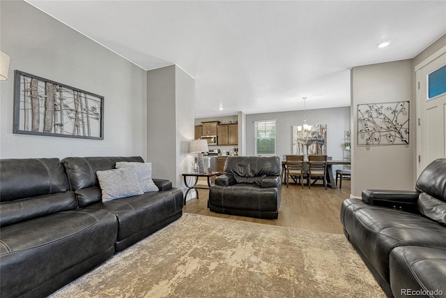 living room with a chandelier and light hardwood / wood-style floors