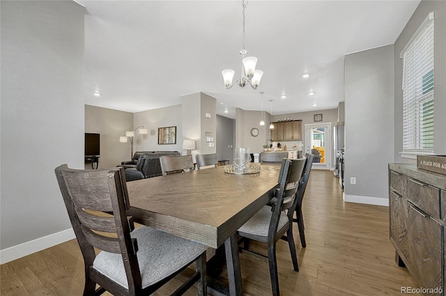 dining area featuring an inviting chandelier and dark hardwood / wood-style floors