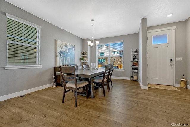 dining room featuring an inviting chandelier and hardwood / wood-style floors