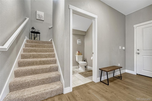 staircase with hardwood / wood-style flooring