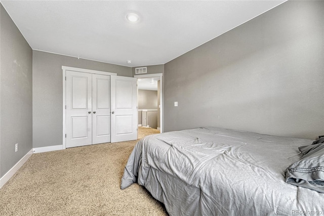 carpeted bedroom featuring a closet