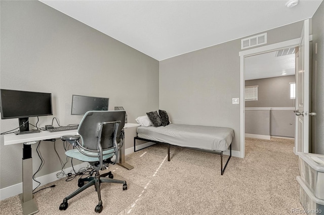 carpeted bedroom with lofted ceiling