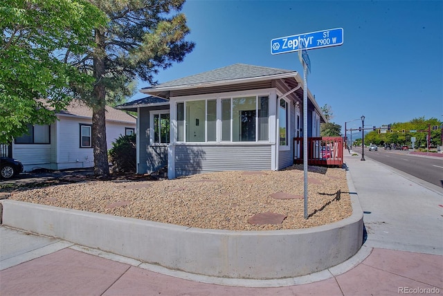 5723 Zephyr St, Arvada, CO 80002 - view of front of home with roof with shingles and a sunroom