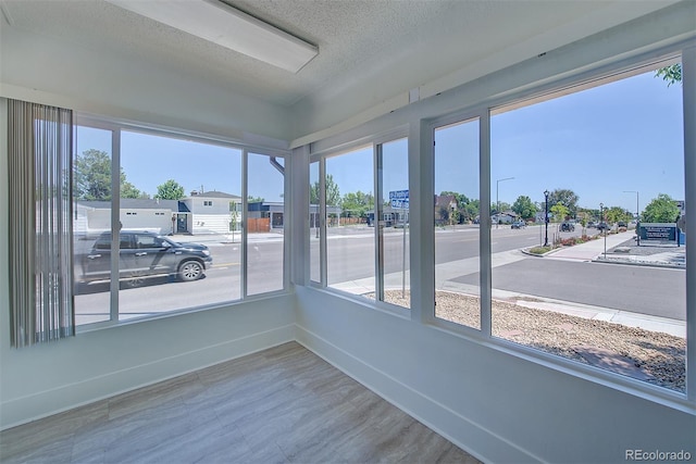 5723 Zephyr St, Arvada, CO 80002 - unfurnished sunroom with baseboards, wood finished floors, and a textured ceiling
