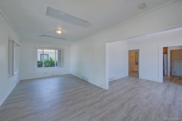5723 Zephyr St, Arvada, CO 80002 - spare room featuring a textured ceiling, baseboards, wood finished floors, crown molding, and a smoke detector