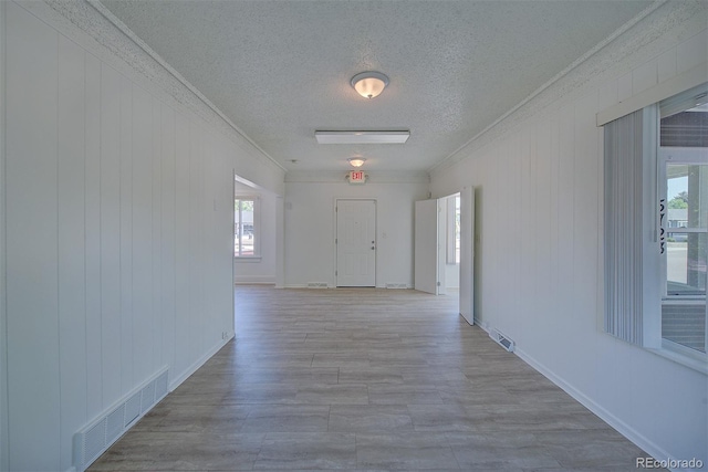 5723 Zephyr St, Arvada, CO 80002 - hall with a textured ceiling, crown molding, wood finished floors, and baseboards