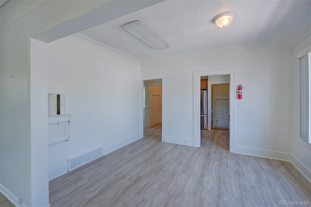 5723 Zephyr St, Arvada, CO 80002 - unfurnished room with a textured ceiling, ornamental molding, wood finished floors, and baseboards