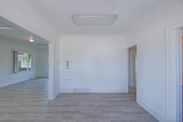 5723 Zephyr St, Arvada, CO 80002 - empty room with ornamental molding, a textured ceiling, baseboards, and wood finished floors