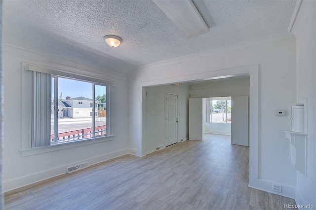 5723 Zephyr St, Arvada, CO 80002 - empty room with a textured ceiling, wood finished floors, baseboards, and crown molding