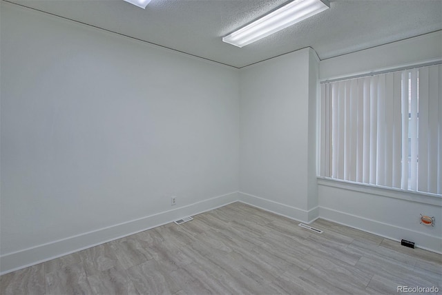 5723 Zephyr St, Arvada, CO 80002 - empty room with baseboards, light wood finished floors, and a textured ceiling