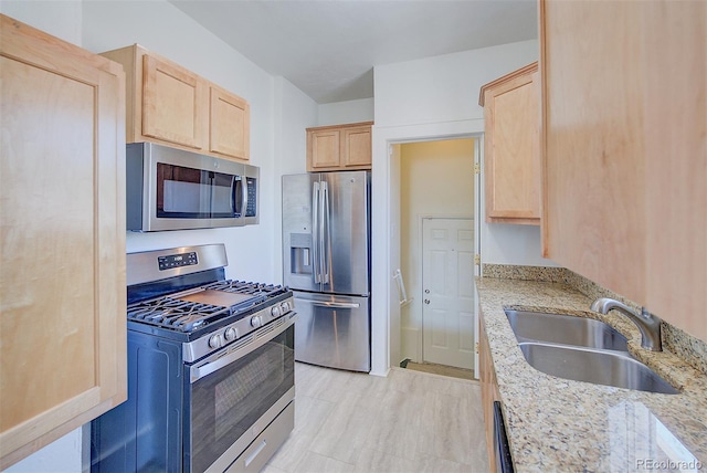 5723 Zephyr St, Arvada, CO 80002 - kitchen featuring stainless steel appliances, light brown cabinets, a sink, and light stone countertops