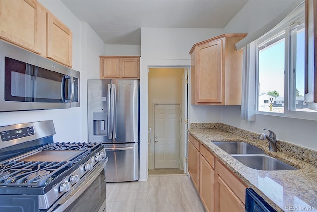 5723 Zephyr St, Arvada, CO 80002 - kitchen featuring stainless steel appliances, a sink, light brown cabinets, and light stone counters