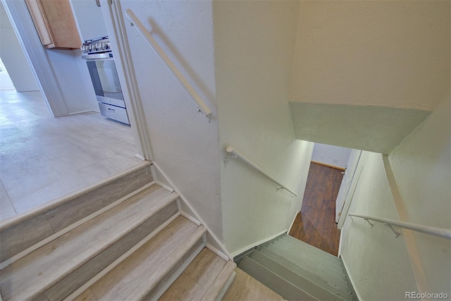 5723 Zephyr St, Arvada, CO 80002 - staircase featuring a textured wall