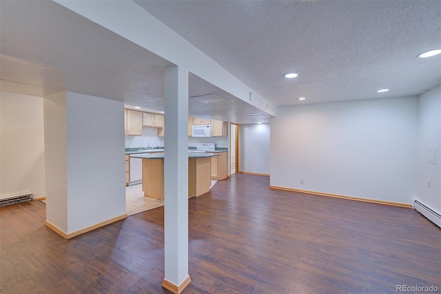 5723 Zephyr St, Arvada, CO 80002 - finished basement featuring a textured ceiling, dark wood-style flooring, recessed lighting, baseboards, and a baseboard radiator