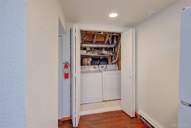 5723 Zephyr St, Arvada, CO 80002 - washroom featuring washing machine and clothes dryer, dark wood-style floors, baseboards, and a textured wall