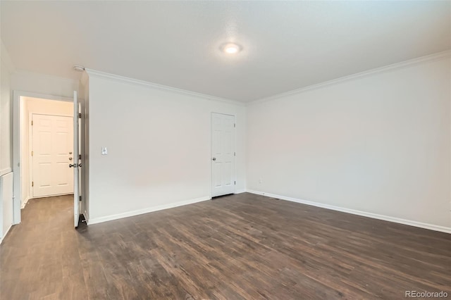 unfurnished room featuring baseboards, ornamental molding, and dark wood-style floors