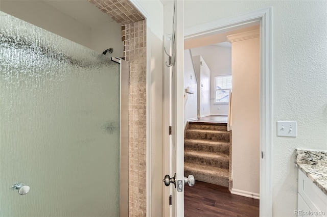 bathroom featuring a stall shower, vanity, and wood finished floors