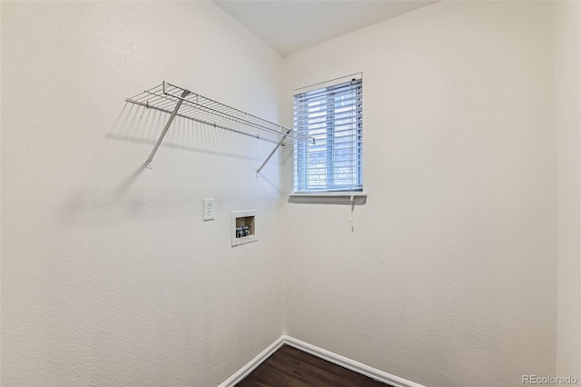 clothes washing area with baseboards, hookup for a washing machine, laundry area, and dark wood-type flooring