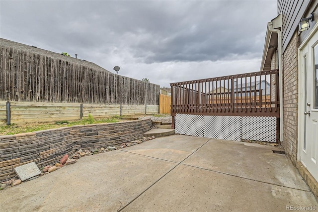 view of patio with a deck and a fenced backyard