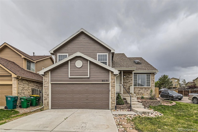 view of front of home featuring concrete driveway, a shingled roof, a garage, and a front lawn