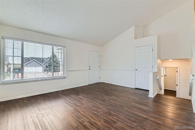 unfurnished living room featuring dark wood-type flooring, baseboards, and high vaulted ceiling