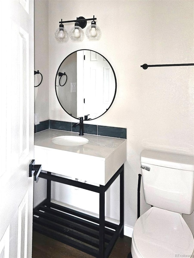 half bath with vanity and toilet