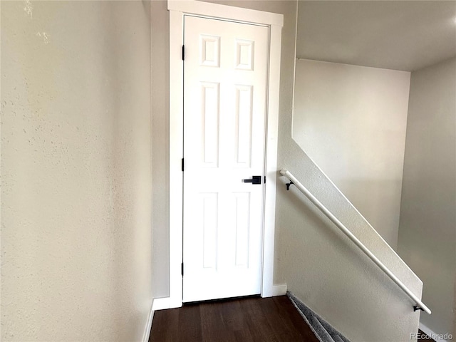 stairway with baseboards and wood finished floors