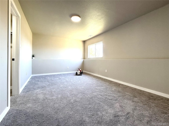 empty room featuring carpet floors and baseboards