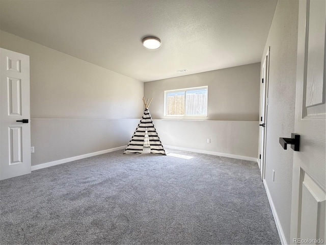 recreation room with carpet floors and baseboards
