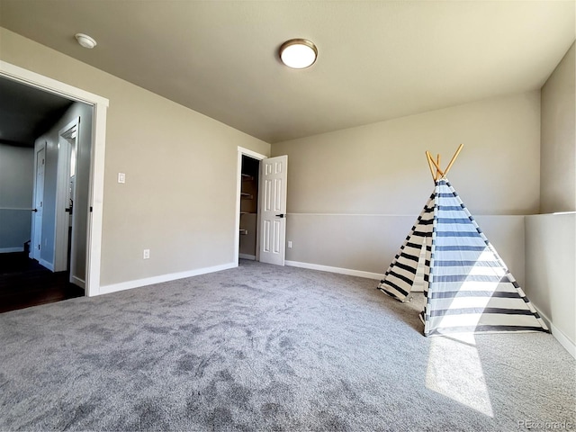 interior space with carpet floors and baseboards