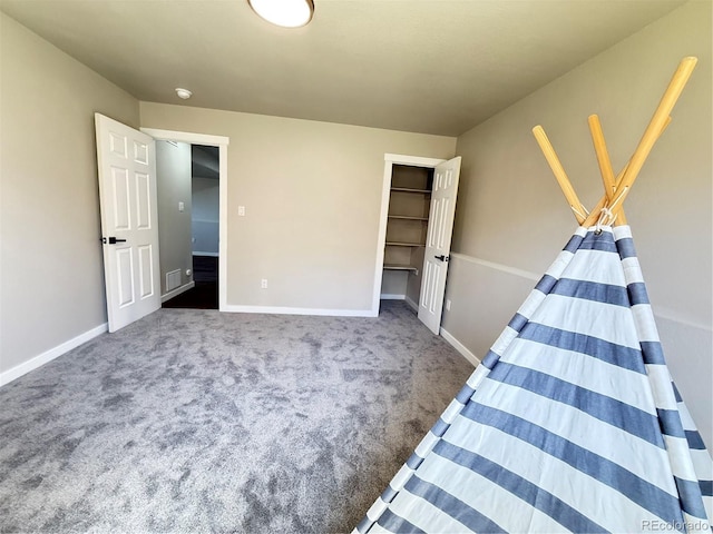 unfurnished bedroom with carpet floors, baseboards, visible vents, and a closet