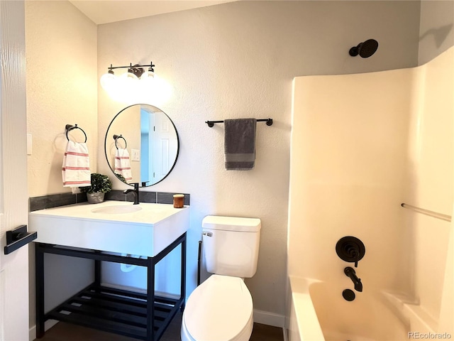 bathroom featuring vanity, baseboards, shower / tub combination, and toilet
