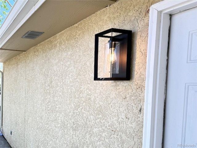 details with visible vents and stucco siding