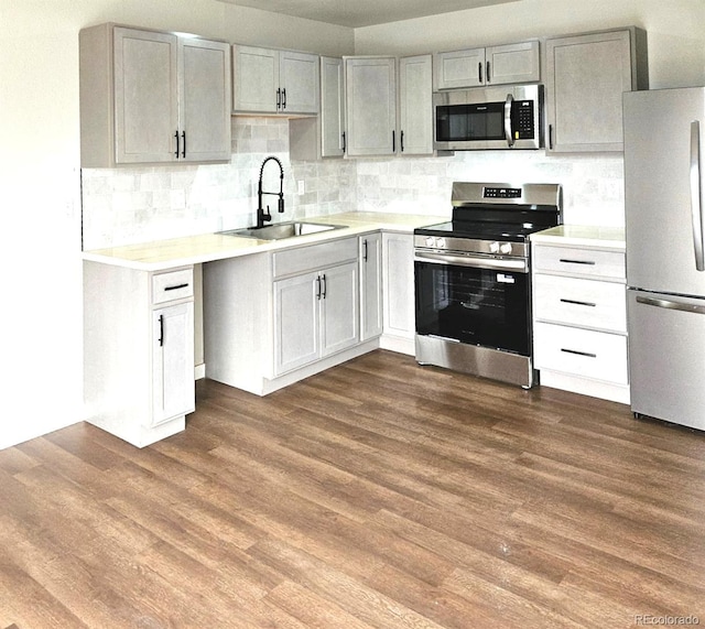 kitchen with light countertops, appliances with stainless steel finishes, and a sink