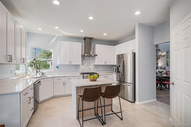 6039 S Ukraine Cir, Aurora, CO 80015 - kitchen with stainless steel appliances, wall chimney exhaust hood, a kitchen bar, a center island, and tasteful backsplash
