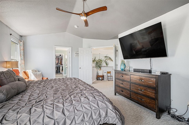 6039 S Ukraine Cir, Aurora, CO 80015 - bedroom featuring light carpet, lofted ceiling, a textured ceiling, and a ceiling fan