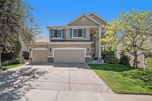 6039 S Ukraine Cir, Aurora, CO 80015 - traditional-style house with stucco siding, stone siding, concrete driveway, and a front lawn