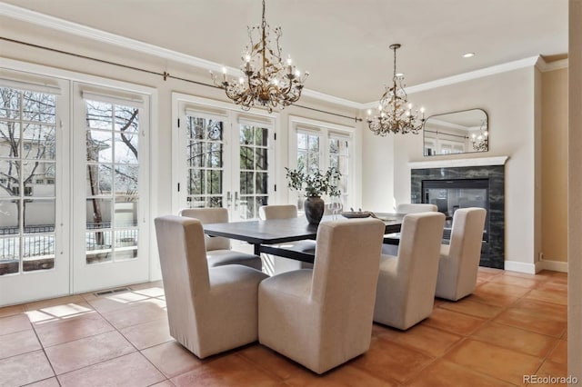 dining room featuring light tile patterned floors, a premium fireplace, crown molding, and a healthy amount of sunlight