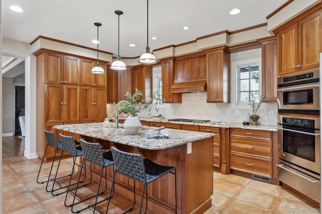 kitchen featuring tasteful backsplash, appliances with stainless steel finishes, brown cabinetry, and a warming drawer