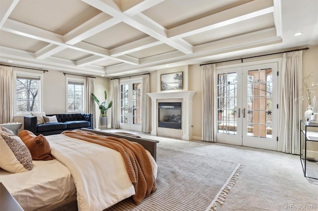 carpeted bedroom featuring access to exterior, french doors, and coffered ceiling