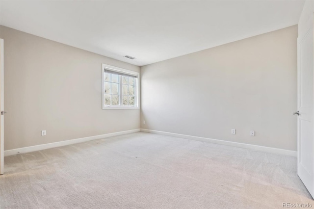 unfurnished room with baseboards, visible vents, and light colored carpet