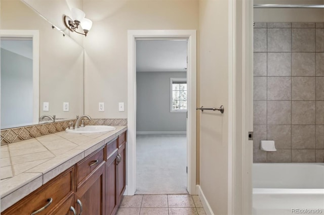 bathroom featuring vanity, baseboards, and tile patterned floors