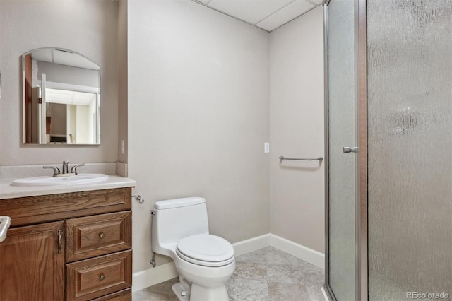 bathroom with toilet, vanity, baseboards, tile patterned floors, and a shower with door