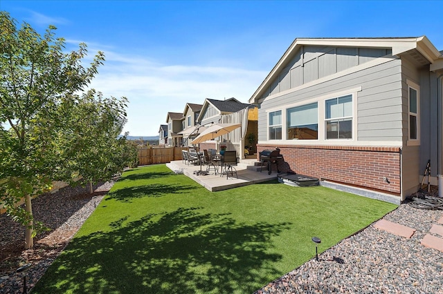 back of house with a yard and a patio area