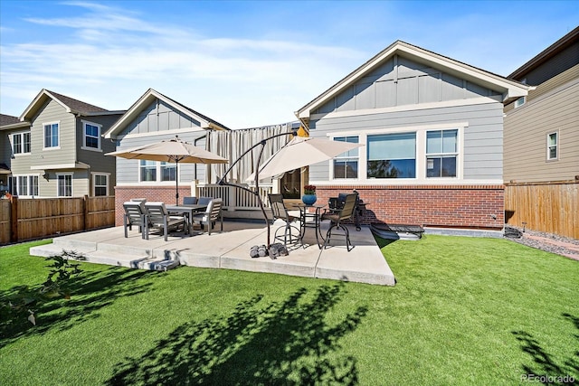 rear view of house featuring a yard and a patio area